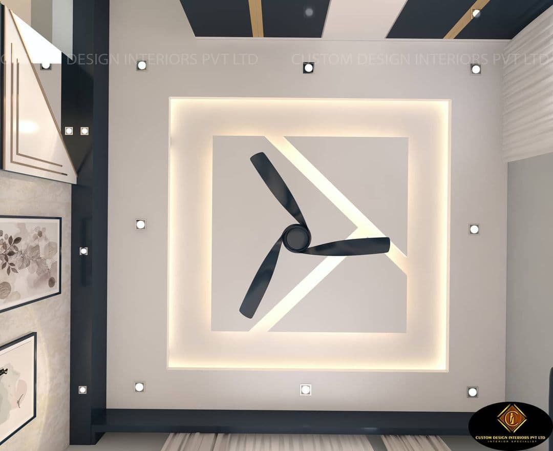 Modern white false ceiling featuring a backlit square recess and a central black three-blade fan.