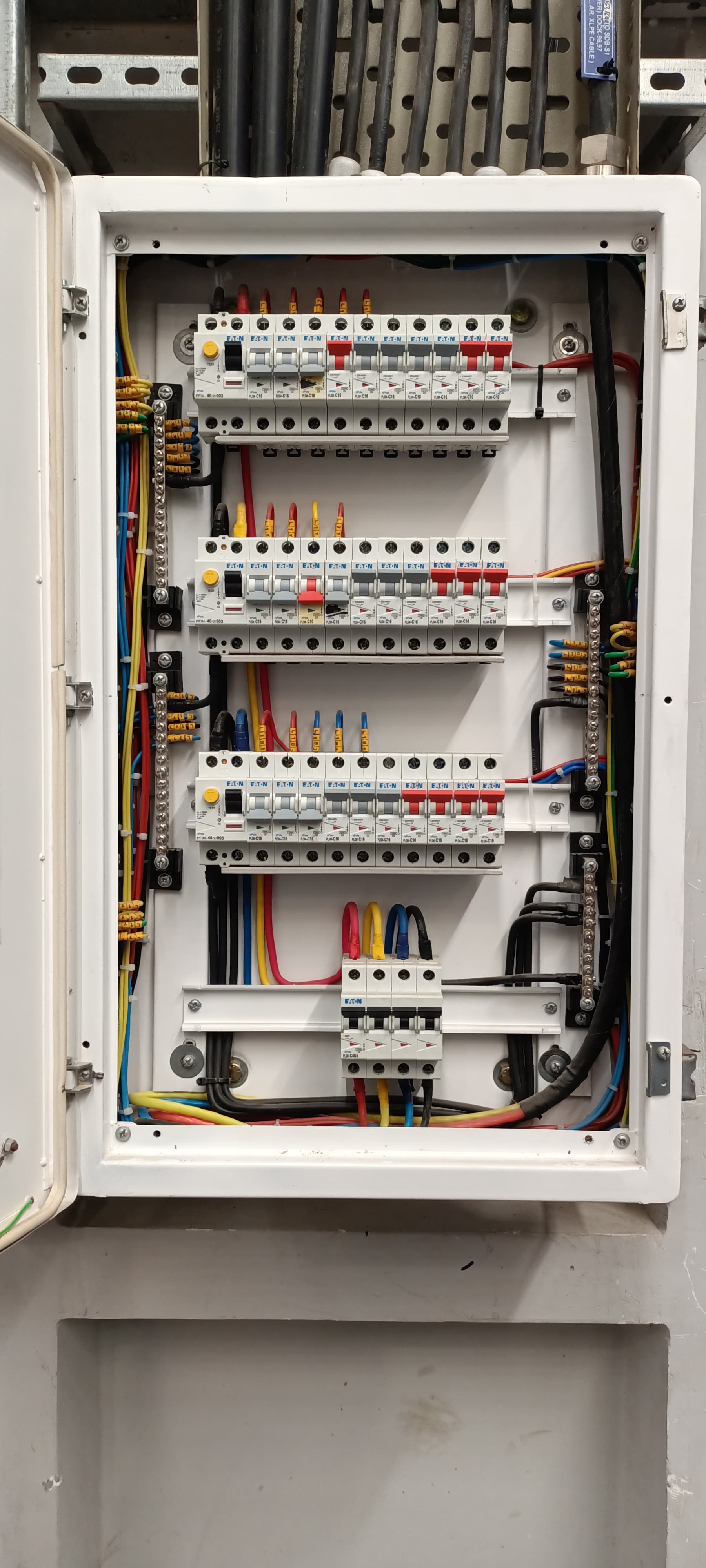 Electrician hands installing modern EV charging station on residential garage wall with precision and expertise